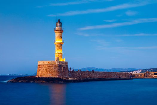 Venetian harbour and lighthouse in old harbour of Chania at sunset, Crete, Greece. Old venetian lighthouse in Chania, Greece. Lighthouse of the old Venetian port in Chania, Greece.