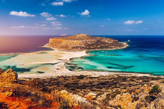Fantastic panorama of Balos Lagoon and Gramvousa island on Crete, Greece. Cap tigani in the center. Balos beach on Crete island, Greece. Tourists relax and bath in crystal clear water of Balos beach.