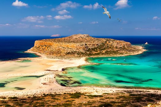 Balos Lagoon and Gramvousa island on Crete with seagulls flying over, Greece. Cap tigani in the center. Balos beach on Crete island, Greece. Crystal clear water of Balos beach.