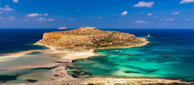 Fantastic panorama of Balos Lagoon and Gramvousa island on Crete, Greece. Cap tigani in the center. Balos beach on Crete island, Greece. Tourists relax and bath in crystal clear water of Balos beach.