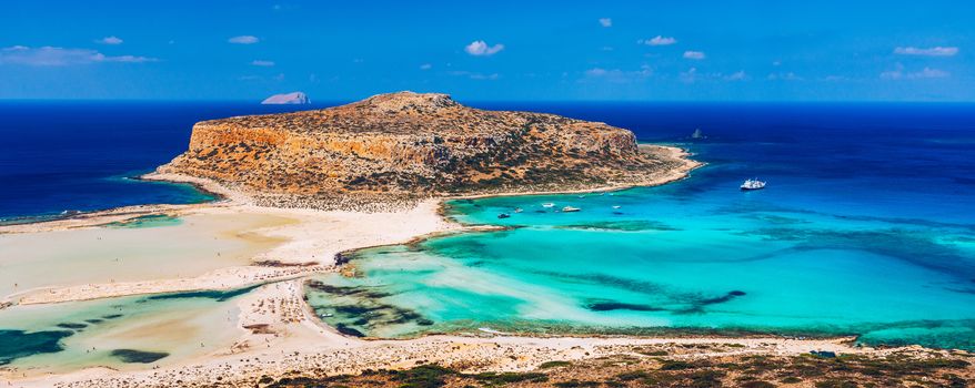 Fantastic panorama of Balos Lagoon and Gramvousa island on Crete, Greece. Cap tigani in the center. Balos beach on Crete island, Greece. Tourists relax and bath in crystal clear water of Balos beach.