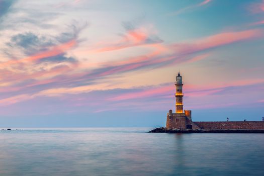 Venetian harbour and lighthouse in old harbour of Chania at sunset, Crete, Greece. Old venetian lighthouse in Chania, Greece. Lighthouse of the old Venetian port in Chania, Greece.