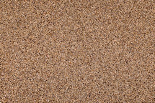 Sand surface and background. Sand Texture. Brown sand. Background from fine sand. Sand background. Closeup of sand pattern of a beach in the summer.