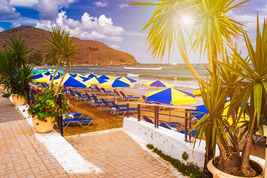 View of sunbeds awaiting tourists at the Greek island resort of Georgioupolis on Crete north coast. Georgioupoli is a resort village and former municipality in the Chania regional unit, Crete, Greece.