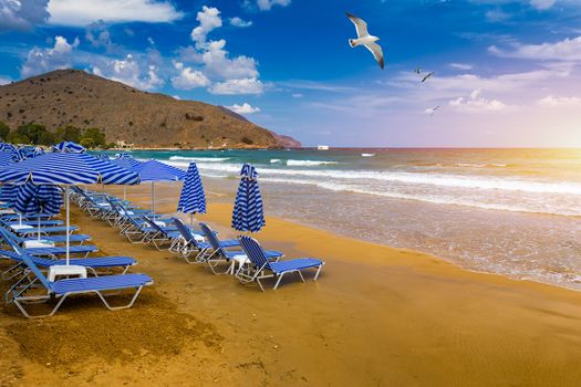 View of sunbeds awaiting tourists at the Greek island resort of Georgioupolis on Crete north coast. Georgioupoli is a resort village and former municipality in the Chania regional unit, Crete, Greece.