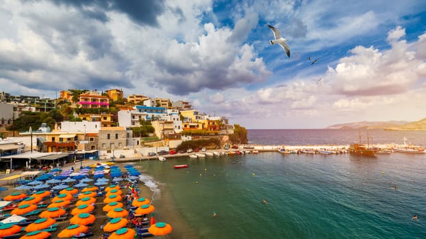 Panorama of Harbour with vessels, boats, beach and lighthouse in Bali at sunrise, Rethymno, Crete, Greece. Famous summer resort in Bali village, near Rethimno, Crete, Greece. 