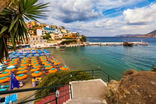 Panorama of Harbour with vessels, boats, beach and lighthouse in Bali at sunrise, Rethymno, Crete, Greece. Famous summer resort in Bali village, near Rethimno, Crete, Greece. 