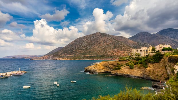 Panorama of Harbour with vessels, boats, beach and lighthouse in Bali at sunrise, Rethymno, Crete, Greece. Famous summer resort in Bali village, near Rethimno, Crete, Greece. 