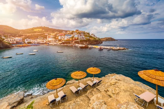 Panorama of Harbour with vessels, boats, beach and lighthouse in Bali at sunrise, Rethymno, Crete, Greece. Famous summer resort in Bali village, near Rethimno, Crete, Greece. 