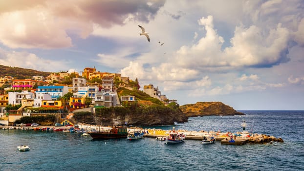 Panorama of Harbour with vessels, boats, beach and lighthouse in Bali at sunrise, Rethymno, Crete, Greece. Famous summer resort in Bali village, near Rethimno, Crete, Greece. 