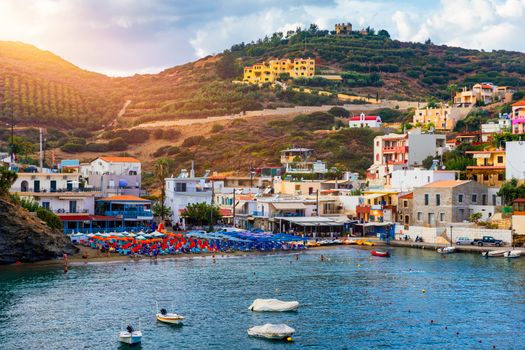 Panorama of Harbour with vessels, boats, beach and lighthouse in Bali at sunrise, Rethymno, Crete, Greece. Famous summer resort in Bali village, near Rethimno, Crete, Greece. 