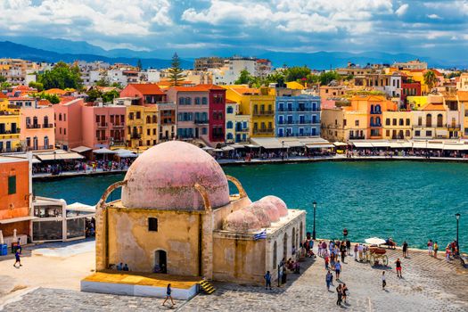 Mosque in the old Venetian harbor of Chania town on Crete island, Greece. Old mosque in Chania. Janissaries or Kioutsouk Hassan Mosque in Chania Crete. Turkish mosque in Chania bay. Crete, Greece.