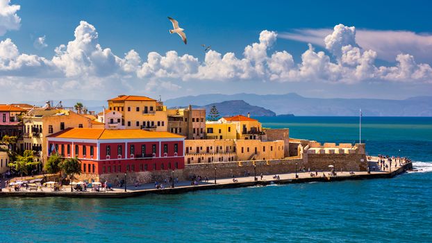 Old port of Chania with flying seagulls. Landmarks of Crete island. Bay of Chania at sunny summer day, Crete Greece. View of the old port of Chania, Crete, Greece. The port of chania, or Hania. 