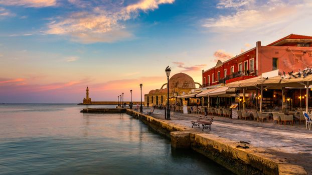 Venetian Harbour of the city of Chania at sunrise with turquoise water, Crete, Greece. View of the old port of Chania on Crete, Greece. Chania, Crete, Greece. View of the old port of Chania on Crete.