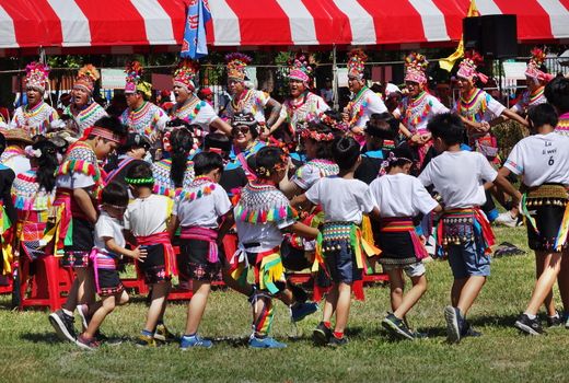 KAOHSIUNG, TAIWAN -- SEPTEMBER 29, 2018: Members of the indigenous Amis tribe in traditional costumes participate in the yearly harvest festival.