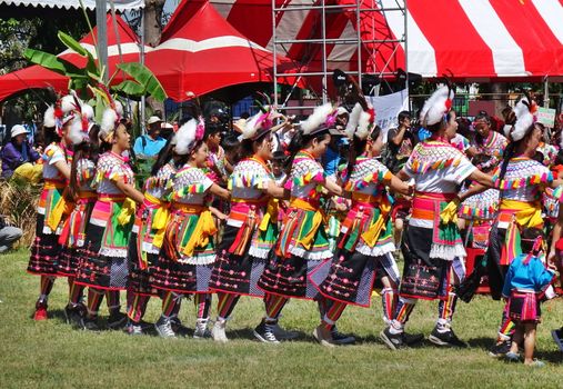 KAOHSIUNG, TAIWAN -- SEPTEMBER 29, 2018: Members of the indigenous Amis tribe in traditional costumes participate in the yearly harvest festival.