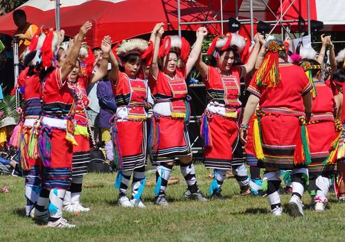 KAOHSIUNG, TAIWAN -- SEPTEMBER 29, 2018: Members of the indigenous Amis tribe in traditional costumes participate in the yearly harvest festival.