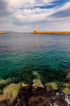 Panorama of venetian harbour waterfront and lighthouse in old harbour of Chania, Crete, Greece. Old venetian lighthouse in Chania, Greece. Lighthouse of the old Venetian port in Chania, Greece.