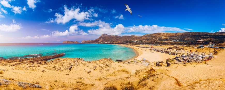 Panorama of turquoise beach Falasarna (Falassarna) in Crete with seagulls flying over, Greece. View of famous paradise sandy deep turquoise beach of Falasarna (Phalasarna), Crete island, Greece.