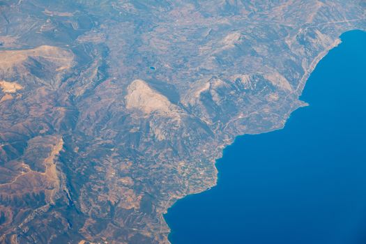 View On Adriatic From Plane. Traveling, Holiday, Vacation Concept. View from airplane on Earth surface. Landscape view of islands from the airplane. Greece Islands From Airplane