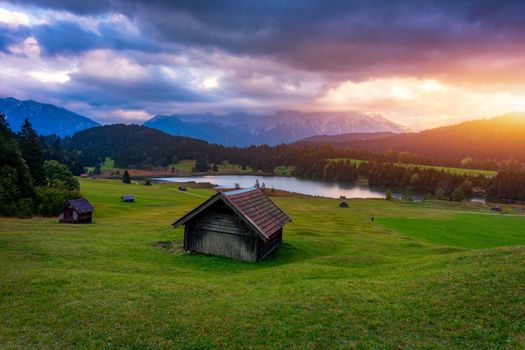 View from flying drone. Astonishing evening view of Wagenbruchsee (Geroldsee) lake with Westliche Karwendelspitze mountain range on background, Bavarian Alps, Germany, Europe.