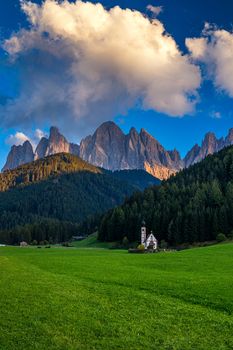 Beautiful landscape with Italian Alps and Church of Saint John located in Ranui, Italy. Val di Funes, Bolzano, Italy. San Giovanni in Ranui church (St John in Ranui church) in the Dolomites, Italy.