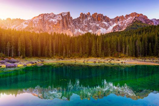 Carezza lake (Lago di Carezza, Karersee) with Mount Latemar, Bolzano province, South tyrol, Italy. Landscape of Lake Carezza or Karersee and Dolomites in background, Nova Levante, Bolzano, Italy.
