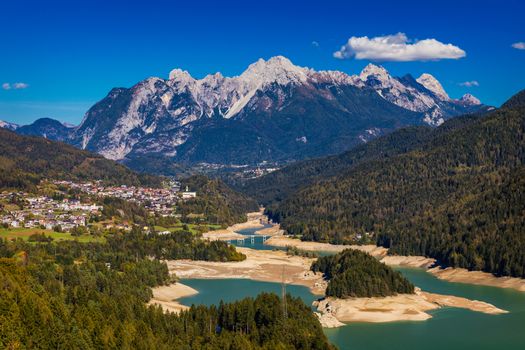 Panoramic view of lake of Centro Cadore in the Alps in Italy, Dolomites, near Belluno. View of Lake Calalzo, Belluno, Italy. Lake of Centro Cadore in the Alps in Italy, near Belluno.