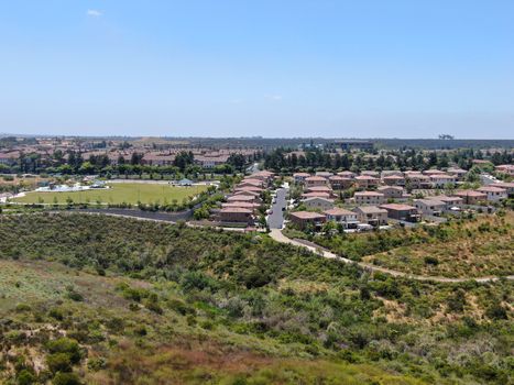 Aerial view of upper middle class neighborhood with residential houses in green valley, South California, USA.