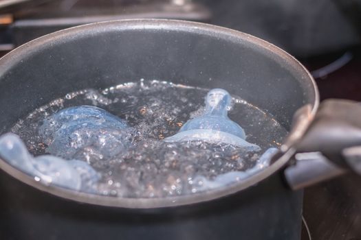 Baby pacifier sterilization in boiling water Casserol