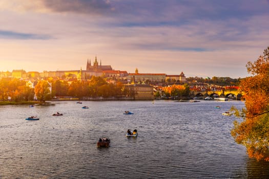 Prague Castle, Charles Bridge and boats on the Vltava river. View of Hradcany Prague Castle, Charles Bridge and a boats on the Vltava river in the capital of the Czechia. Boat cruise on Vltava river.