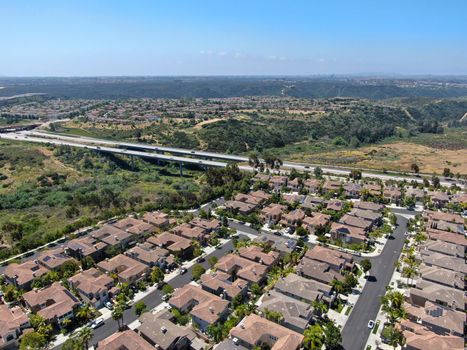 Aerial view of upper middle class neighborhood with residential houses in green valley, South California, USA.