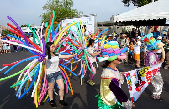 KAOHSIUNG, TAIWAN -- OCTOBER 1, 2017: Balloon artists take part in a street parade at the opening of the 2017 Ecomobility Festival.