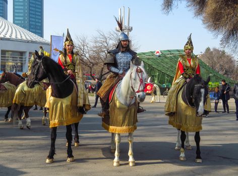 Almaty, Kazakhstan - March 21, 2019: Local people on the horses at national folkloric show Nauryz in Almaty, Kazakhstan