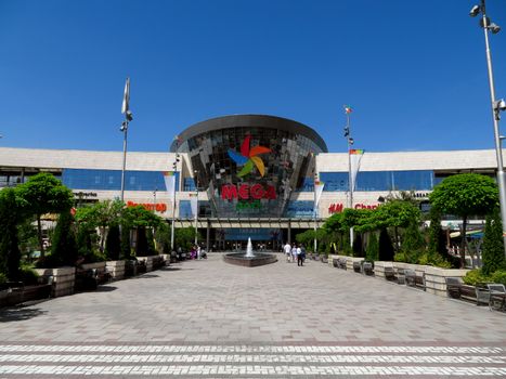 ALMATY, KAZAKHSTAN - June 15, 2019: Shopping and entertainment center Mega Park in Almaty, Kazakhstan. Opened in 2015, it is the largest department store in Almaty. Unidentified people are outside.