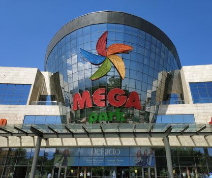 ALMATY, KAZAKHSTAN - June 15, 2019: Shopping and entertainment center Mega Park in Almaty, Kazakhstan. Opened in 2015, it is the largest department store in Almaty. Unidentified people are outside.