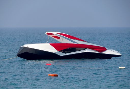 Anchored modern boat at a sea beach