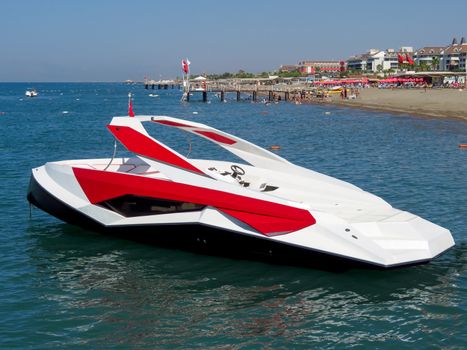 Anchored modern boat at a sea beach