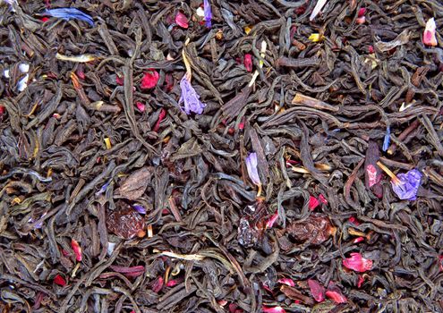 Background of dry tea leaves with barberry.