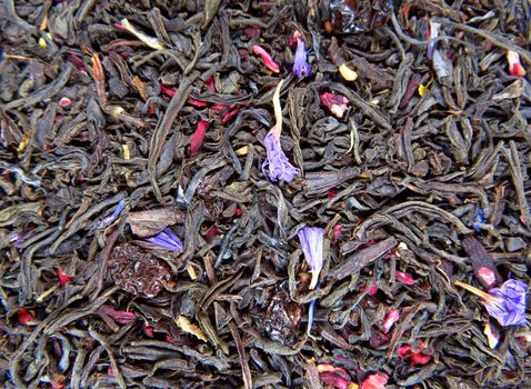 Background of dry tea leaves with barberry.