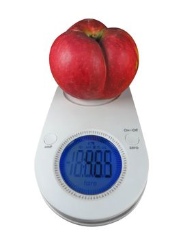 Red apple on kitchen scales isolated on white. Clipping Path included.
