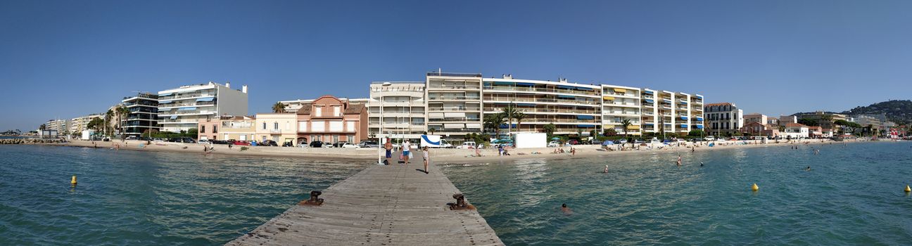 Cannes, France - July 8, 2018: Public beach at the end of the Promenade de la Croisette. Unidentified people relax on the beach.