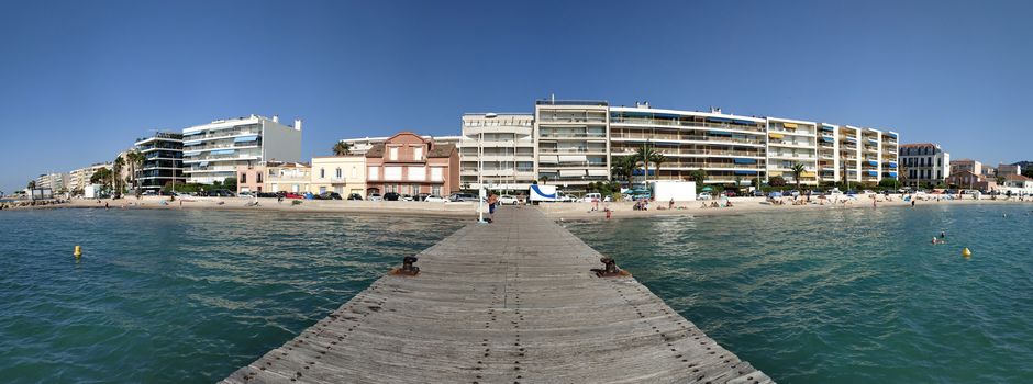 Cannes, France - July 8, 2018: Public beach at the end of the Promenade de la Croisette. Unidentified people relax on the beach.