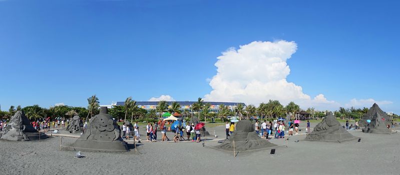 KAOHSIUNG, TAIWAN -- JULY 29, 2018: Visitors enjoy the sand sculptures at the 2018 Chijin Island Black Sand Festival.