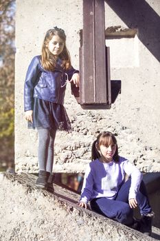 Two girlfriends having fun in a public park in the fall.