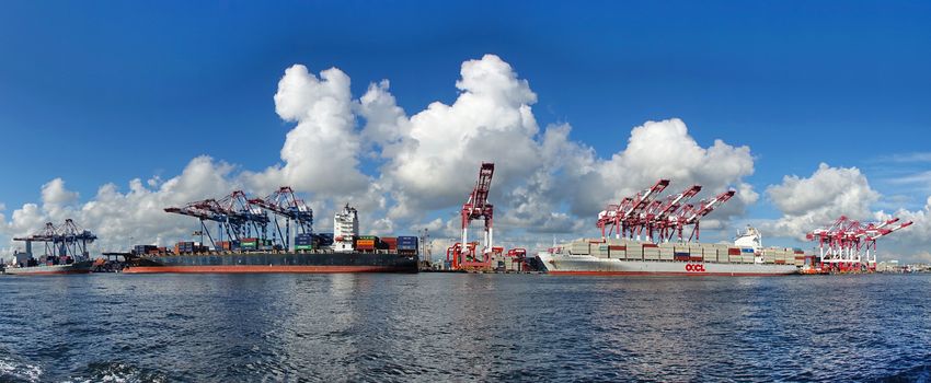 KAOHSIUNG, TAIWAN -- JUNE 2, 2019: Containers are being loaded onto ships in Kaohsiung Port.