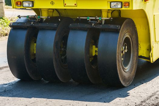 asphalt compactor running outdoors on a sunny day