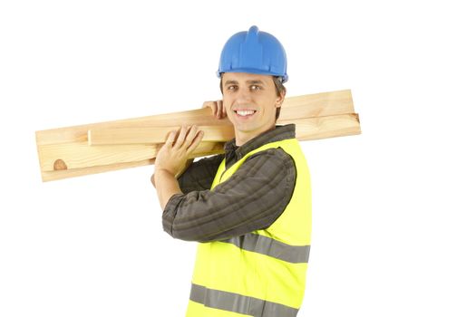 Smiling worker man carrying some planks on his shoulder.
