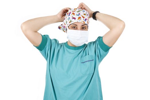 Female nurse putting on her mask, isolated on white background.