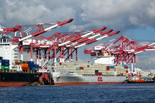 KAOHSIUNG, TAIWAN -- JUNE 2, 2019: Containers are being loaded onto ships in Kaohsiung Port.